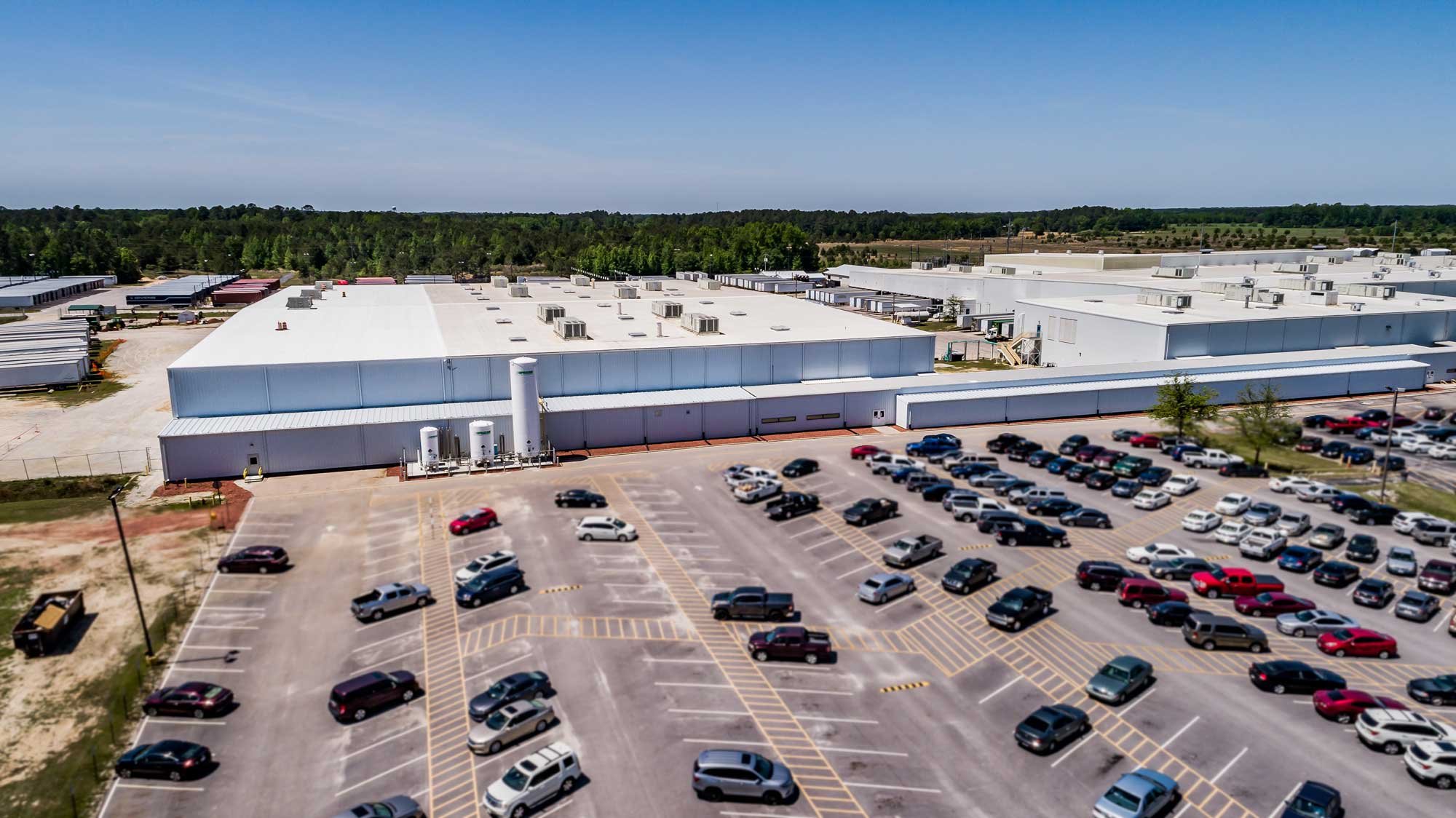 A large industrial building and its parking lot.